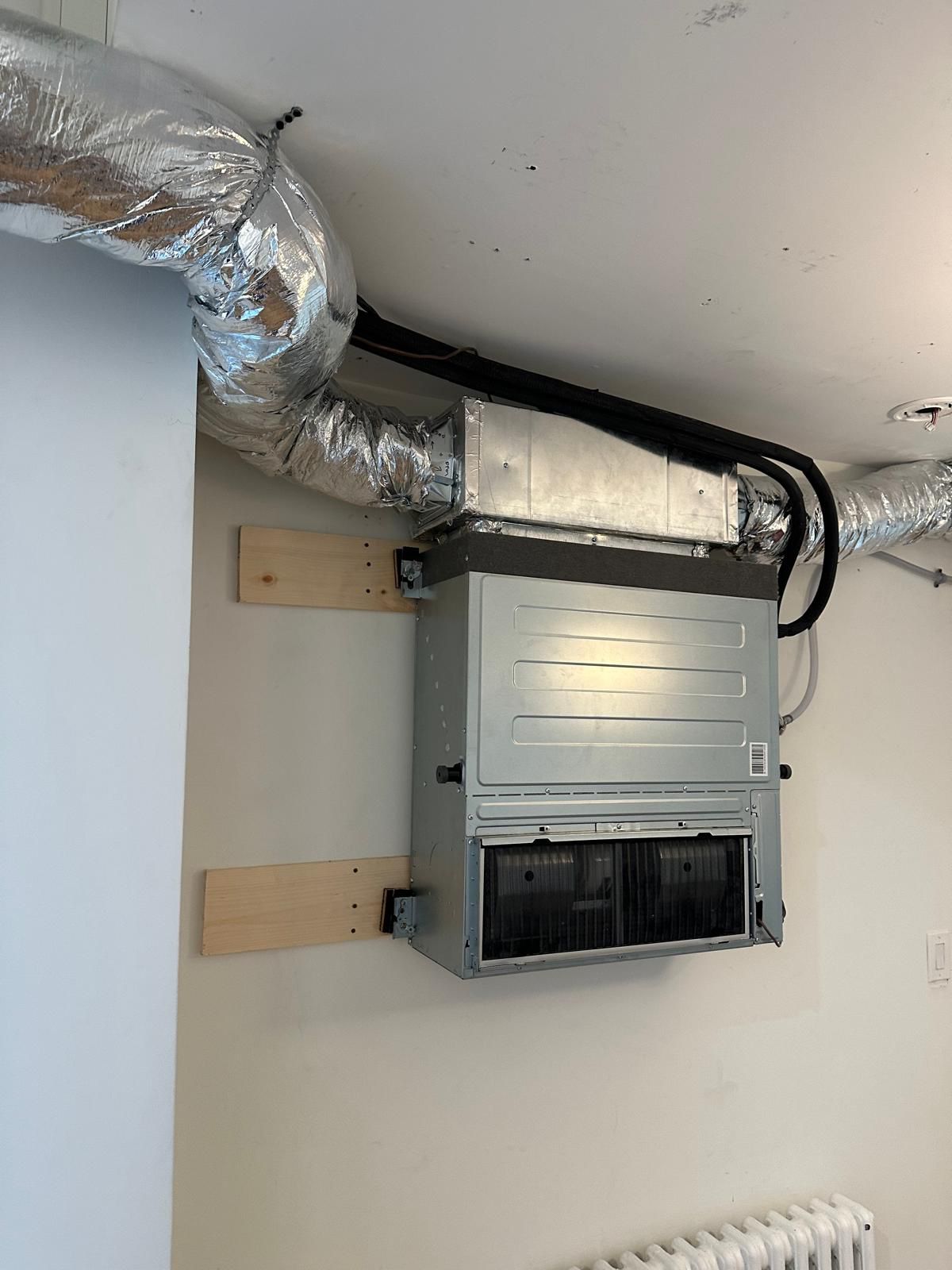 Professional technician servicing central air conditioning system